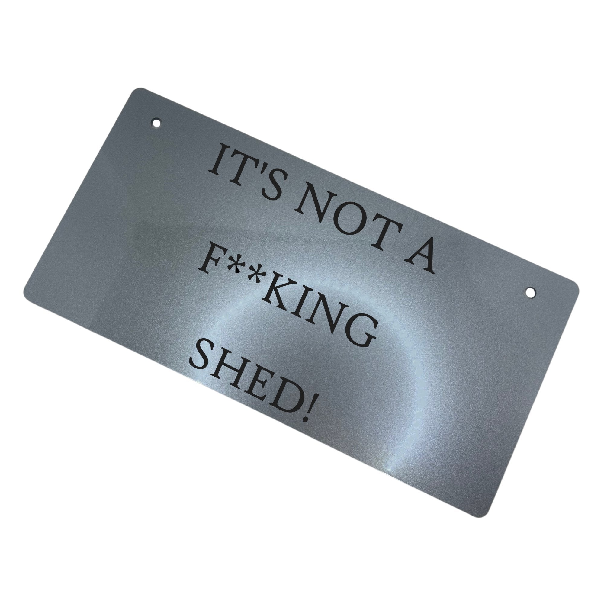 Alt Text: "'IT'S NOT A FKING SHED' Sign in Silver Color" Description: Close-up of a silver-colored acrylic sign with engraved text saying "IT'S NOT A FKING SHED." The sign is crafted from durable 3mm thick acrylic and includes 5mm holes for convenient hanging.