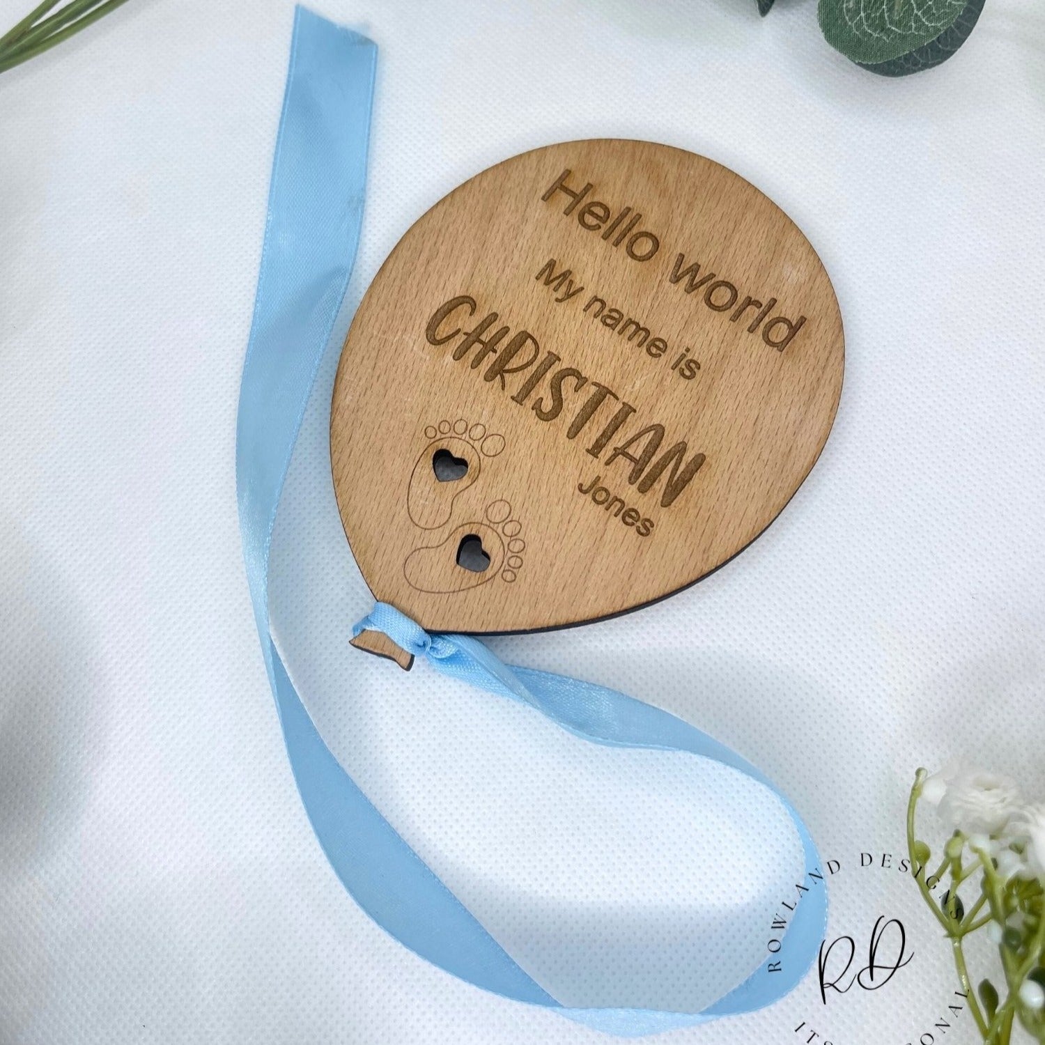 Crafted keepsake for baby showers, featuring intricate details and a choice of ribbon colors