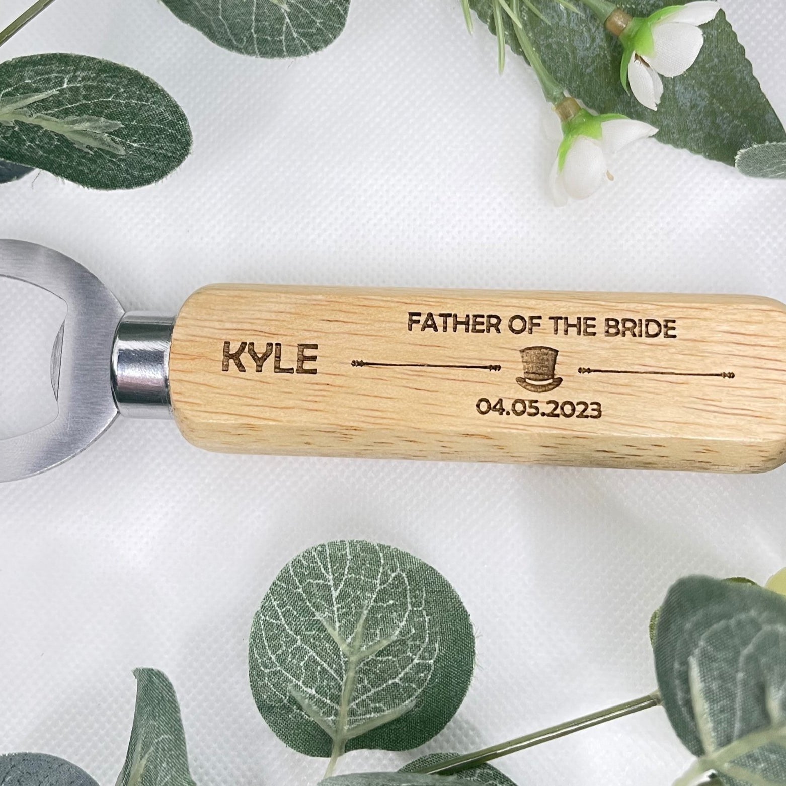 Celebrate your special day with our charming Personalised Wedding Bottle Openers. Handcrafted and laser-engraved with a whimsical hat image, these keepsakes make the perfect wedding or Stag Do gift. With durable stainless steel and natural wood design, each opener is personalised with the recipient's name, role, and wedding date. An ideal memento that combines practicality and sentiment. Remember to hand wash only. Personalisation details needed: name, wedding role, and date.
