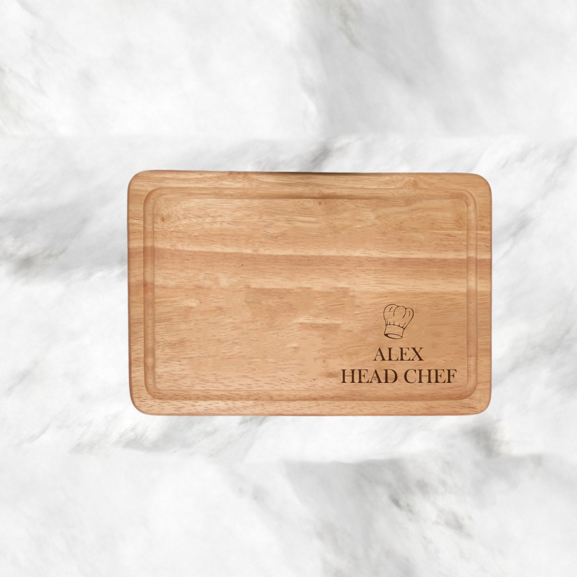 Upgrade your kitchen with our Chef Hat Design Personalised Chopping Board, a blend of style and sentiment. Ideal for any occasion, this 300mmX200mm Hevea Wood board adds a personal touch to your cooking. Enjoy a special culinary experience every time, from day-to-day to special occasions. Hand-wash only for lasting charm.