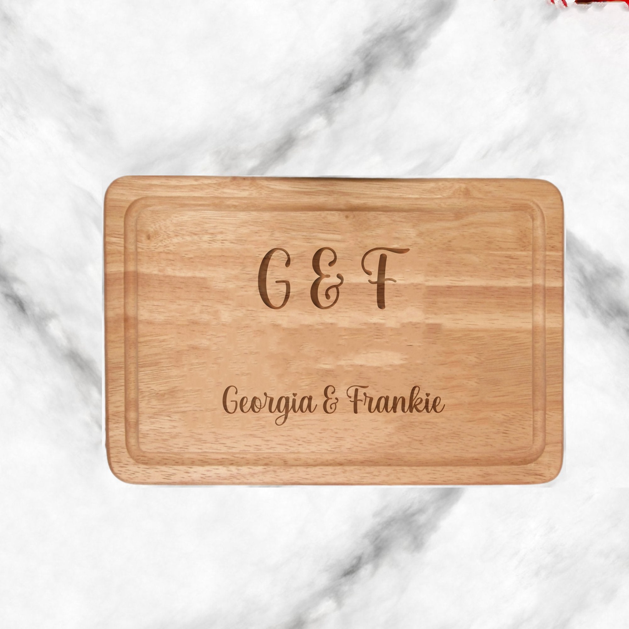 Description: A 300mmX200mm personalised wooden chopping board, meticulously engraved with refined initials and names. Crafted from durable, high-quality wood, this kitchen essential adds a personalised touch to cooking spaces. Ideal for special occasions or as a unique gift. Not dishwasher safe; hand wash only.