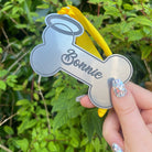 Personalised Dog Remembrance Hanging Bone | Halo: A heartfelt tribute to your furry companion. This keepsake features a yellow hanging ribbon and elegant black engraving. Crafted from durable 3mm thick acrylic, the halo-shaped bone is personalized with your beloved pet's name, ensuring lasting memories. A cherished memento to honor your faithful friend.