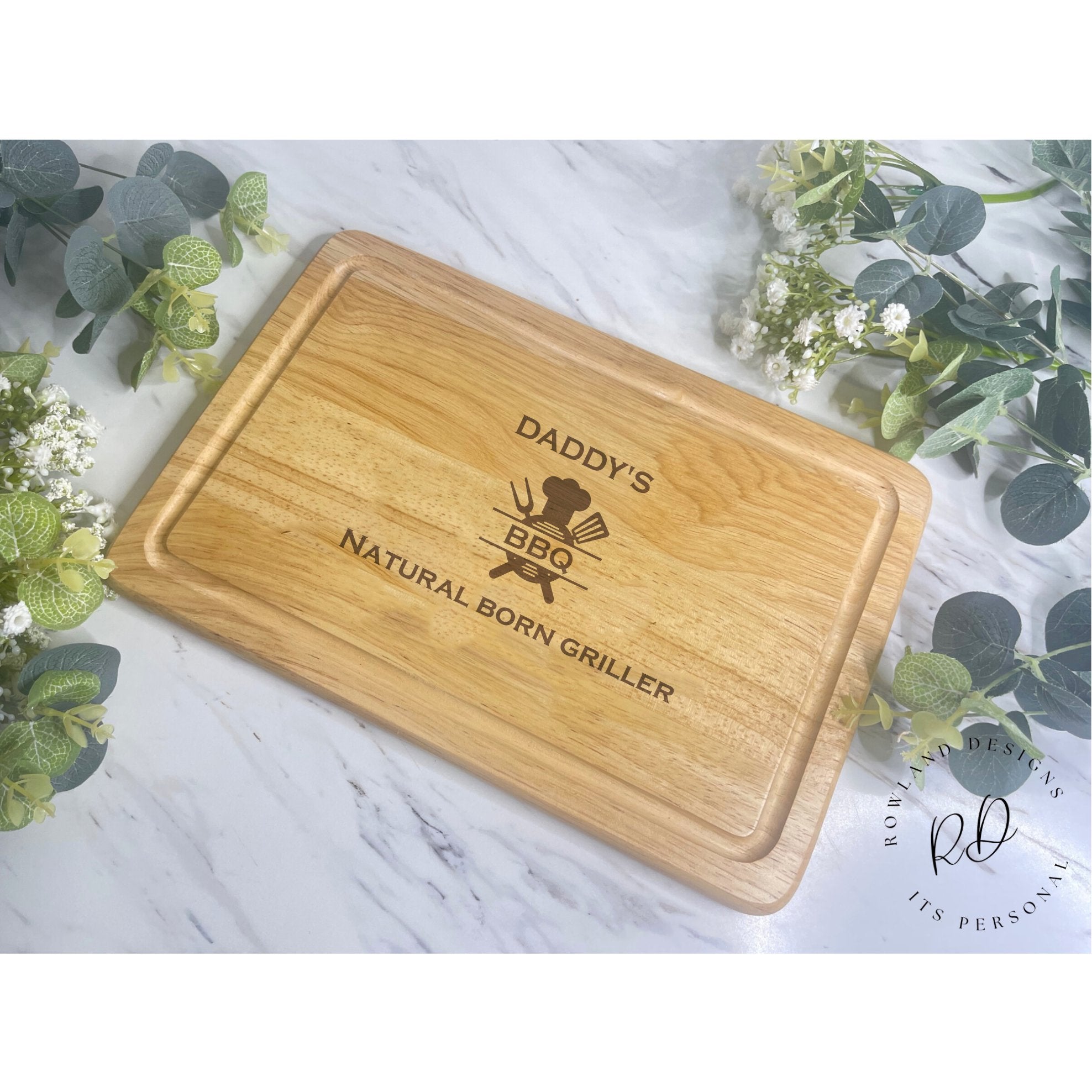 Elevate your cooking prowess with our Personalised Chopping Board - Natural Born Griller. Engraved with your chosen name and a timeless BBQ image, this thoughtful gift is perfect for Christmas, birthdays, or special celebrations. Crafted with care from high-quality Hevea wood, laser-engraved for lasting quality. Dimensions: 300mm x 200mm. Please note: “Natural Born Griller” is not personalizable. Hand-wash only for enduring charm.