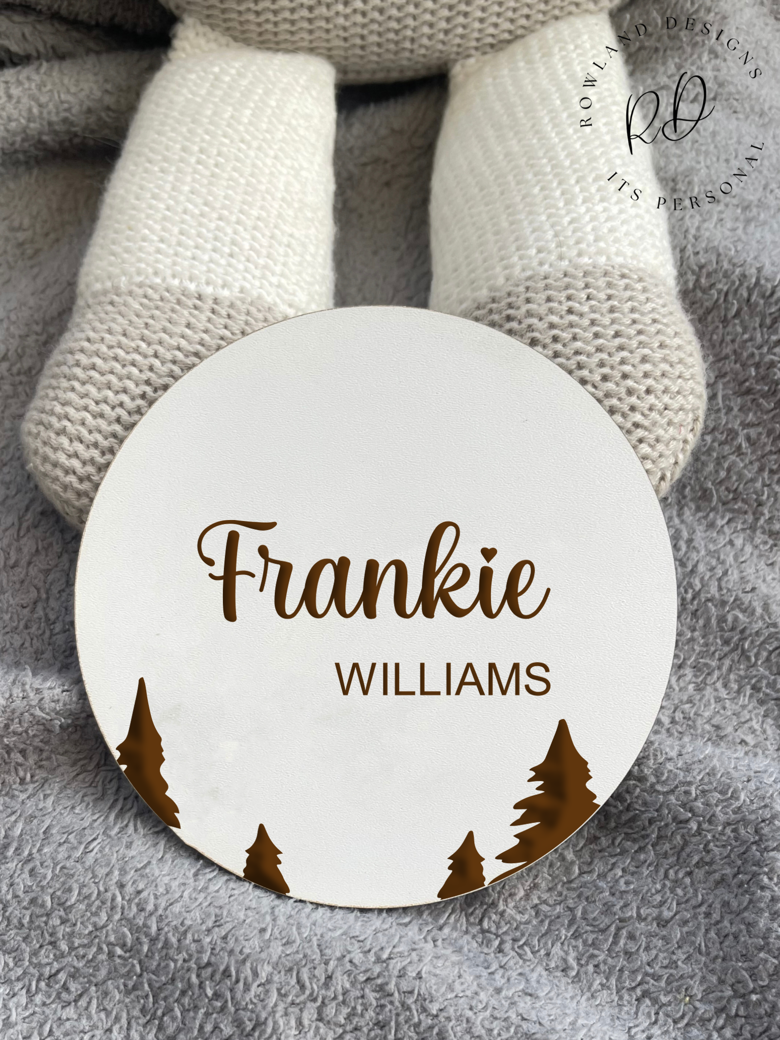 Close-up of a white MDF baby announcement plaque featuring an intricately engraved tree motif and personalised with the baby's name, perfect for nursery decor.