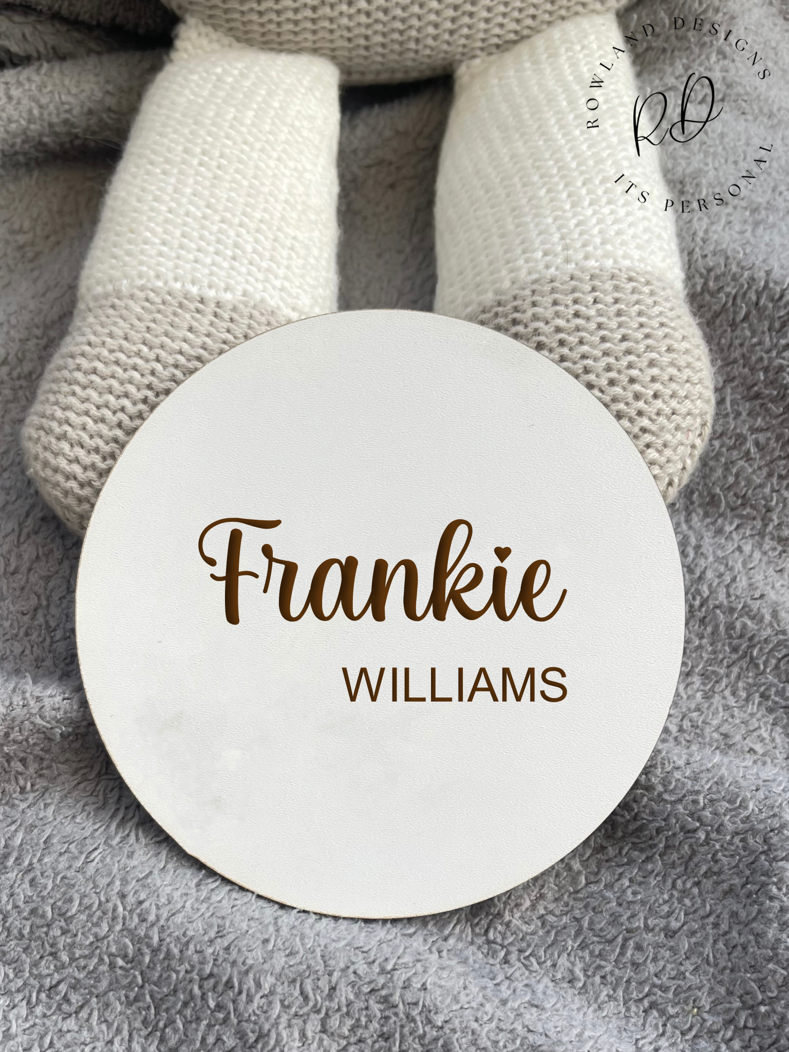 Custom white MDF round baby plaque with a delicate design, showcasing the baby's full name and crafted as a memorable keepsake, ideal for gifting or personal use.