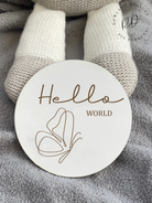 White MDF 'Hello World' baby announcement plaque with a detailed butterfly design, ideal for introducing your baby in style.