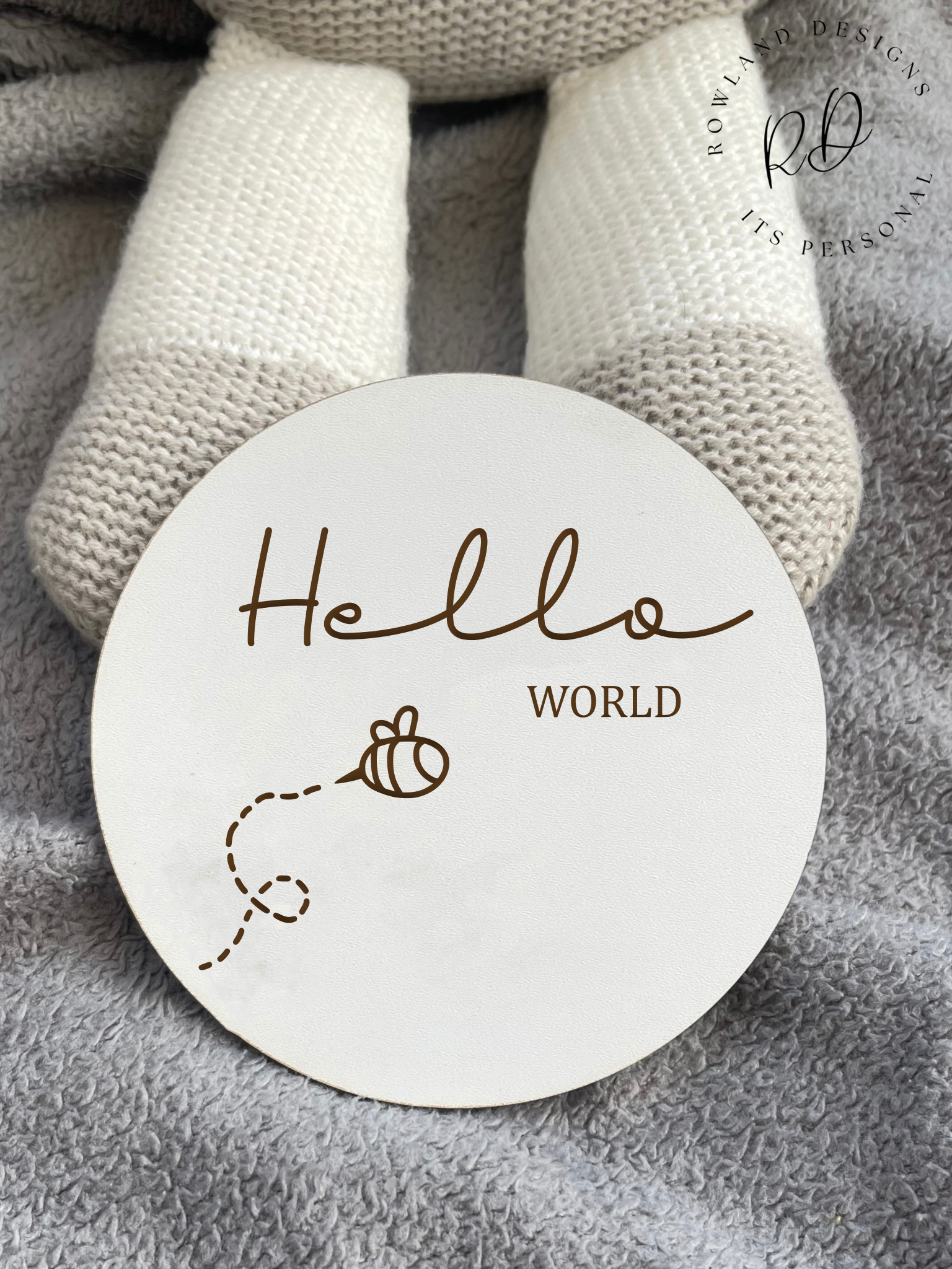 White MDF 'Hello World' baby announcement plaque with a detailed bee design, ideal for introducing your baby in style.