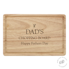 Personalised Father's Day wooden cutting board with intricate custom engraving, showcasing rich wood tones and a grooved edge for spill prevention.