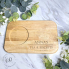 A personalized engraved tea and biscuit board made from durable wood, featuring a built-in slot for a cup and space for biscuits, customized with a laser-engraved message for a unique gift.