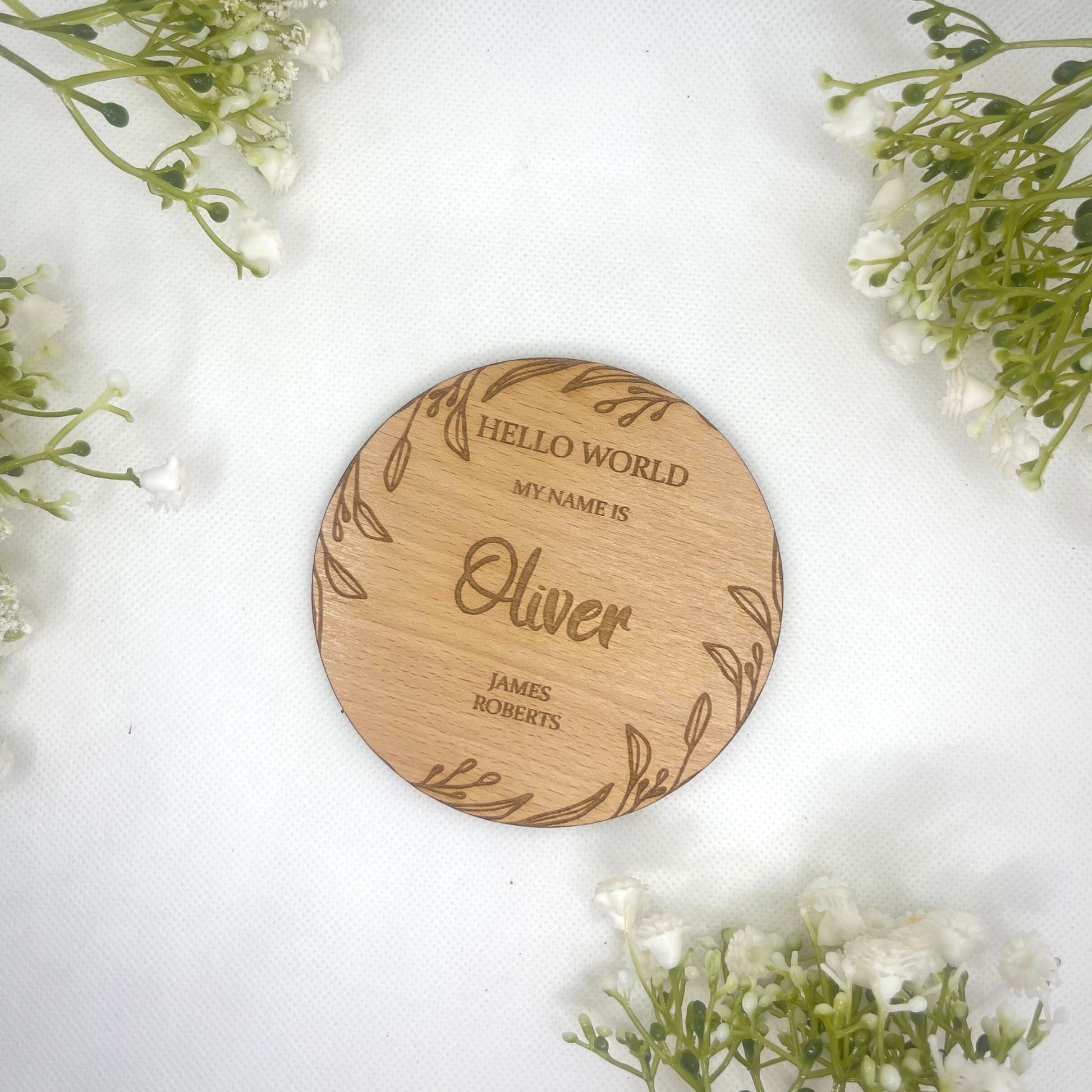 Personalise your plaque with your baby's first middle & last name . This is round with a beautiful leaf design around the edge on the rounded plaque . This would make the perfect first gift for new parents. A beautiful addition to any baby photographs. Made from: Oak veneer SIZE: 10x10cm or 15x15cm (approx) Thickness: 4mm