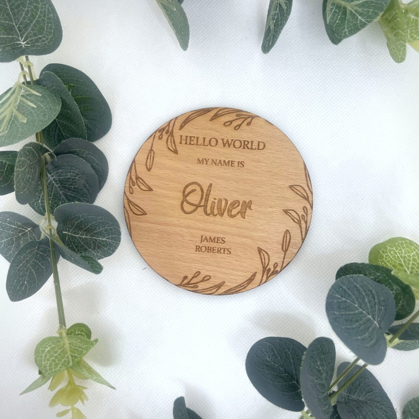 Personalise your plaque with your baby's first middle & last name . This is round with a beautiful leaf design around the edge on the rounded plaque . This would make the perfect first gift for new parents. A beautiful addition to any baby photographs. Made from: Oak veneer SIZE: 10x10cm or 15x15cm (approx) Thickness: 4mm