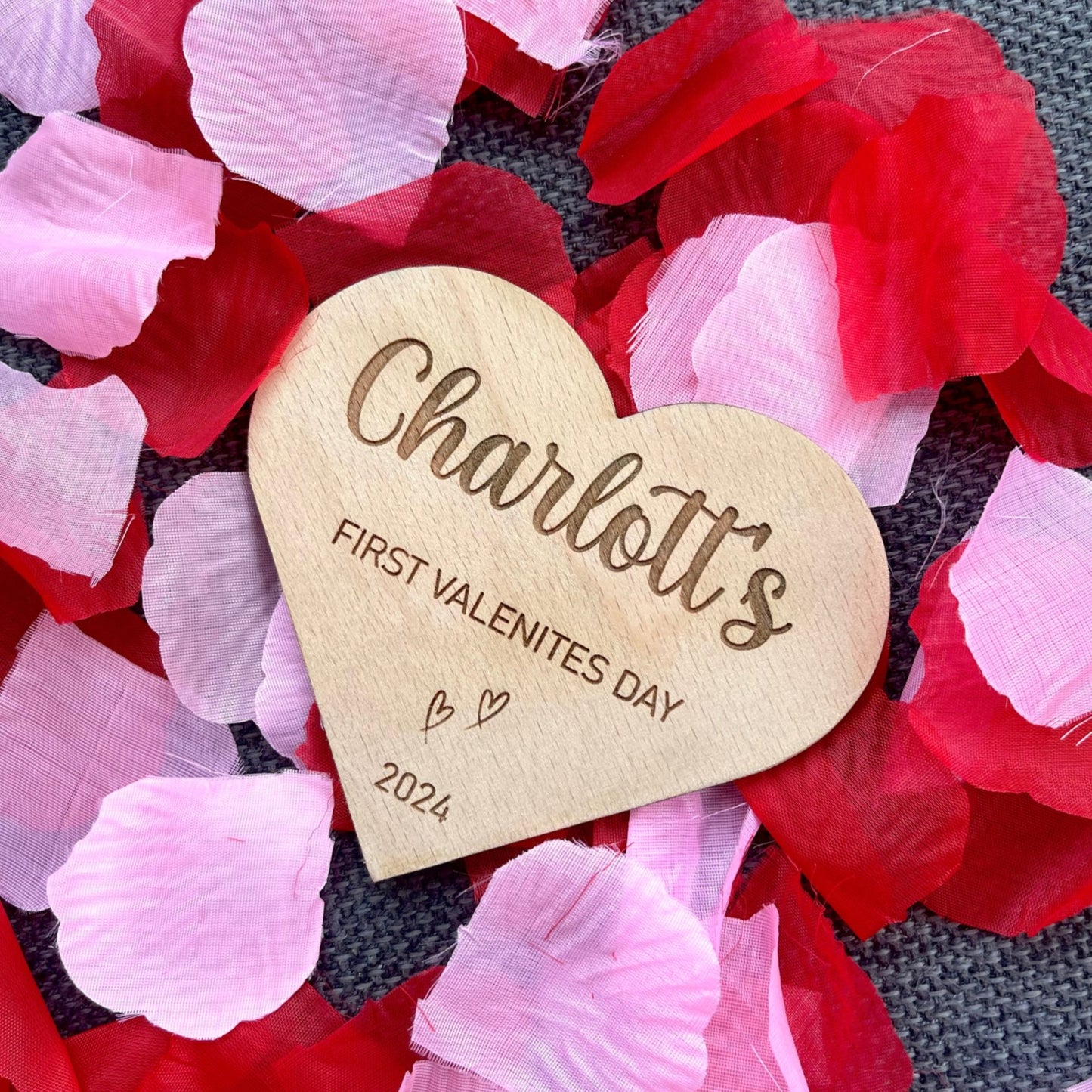 Celebrate your baby's first Valentine's with a personalised heart-shaped announcement plaque. Crafted from beech veneer, measuring 115mm x 100mm with a 4mm thickness – a perfect gift for new parents and a beautiful addition to baby photographs.