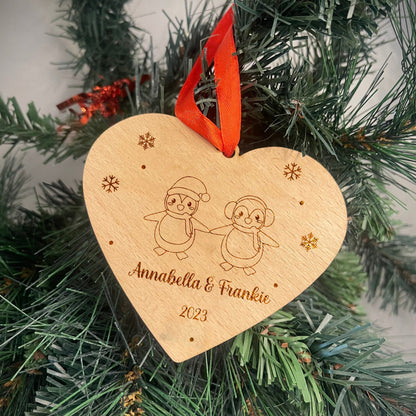 Personalised Wooden Heart-Shaped Bauble with Interlocking Penguins and Snowflakes