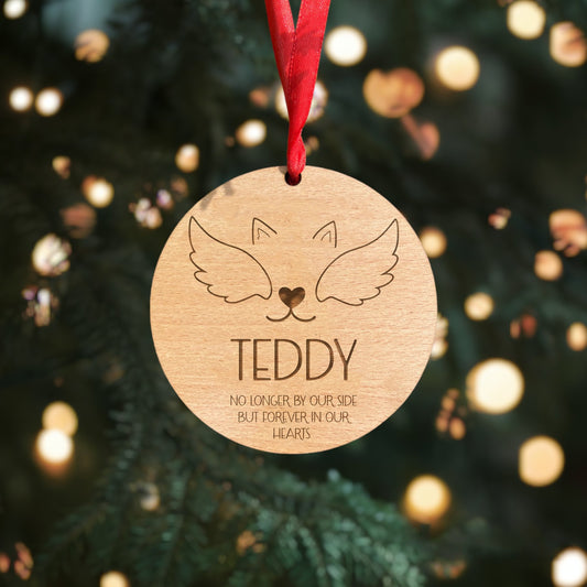Celebrate your beloved pet's memory with our enchanting round memorial bauble. Custom engraved with your pup's name, this design featuring ears, wings, and a cute nose adds a heartfelt touch to your tree. Crafted from high-quality 4mm beech veneer wood, it exudes a classic, rustic charm. Included red ribbon ensures a timeless and festive appearance.
