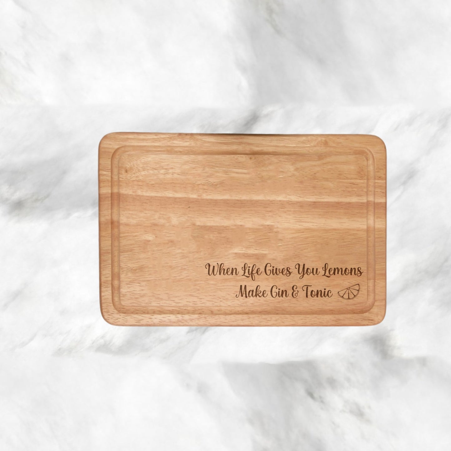 Engraved 'When Life Gives You Lemons, Make Gin & Tonic' chopping board - 300mmX200mm size, timeless design, fade-resistant charm. Elevate your kitchen with a click! With lemon engraved . All engraving is on bottom left of board. 